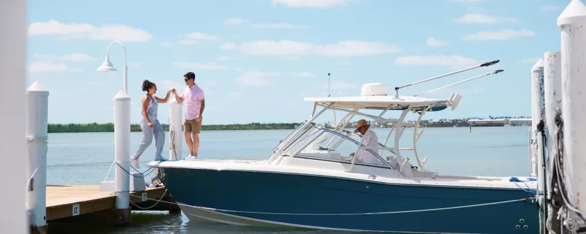 Couple exiting from boat on dock