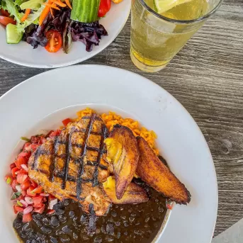 A table topped with plates of food and drinks